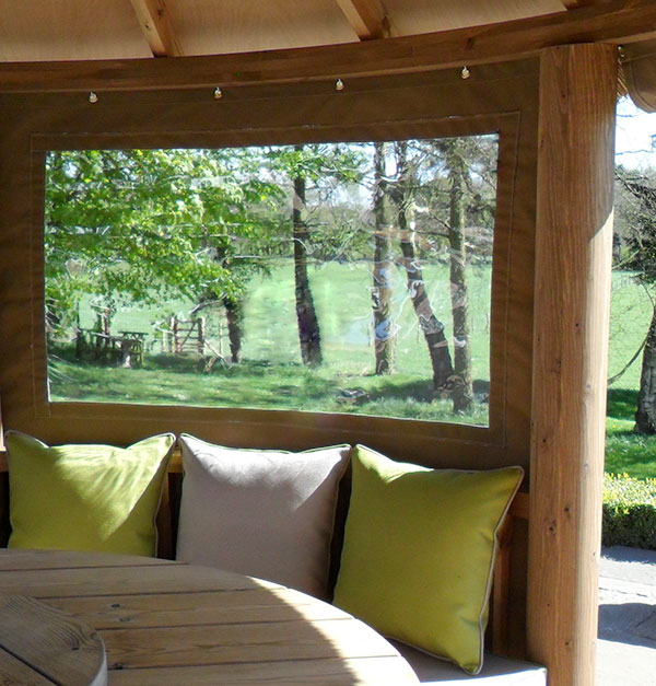 Inside a thatched gazebo looking as closed canvas panelling