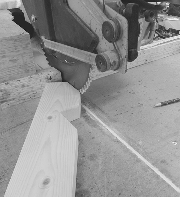 Black and white image of circular saw cutting through wood