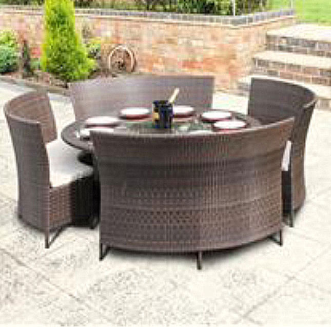 Brown rattan table with benches on patio